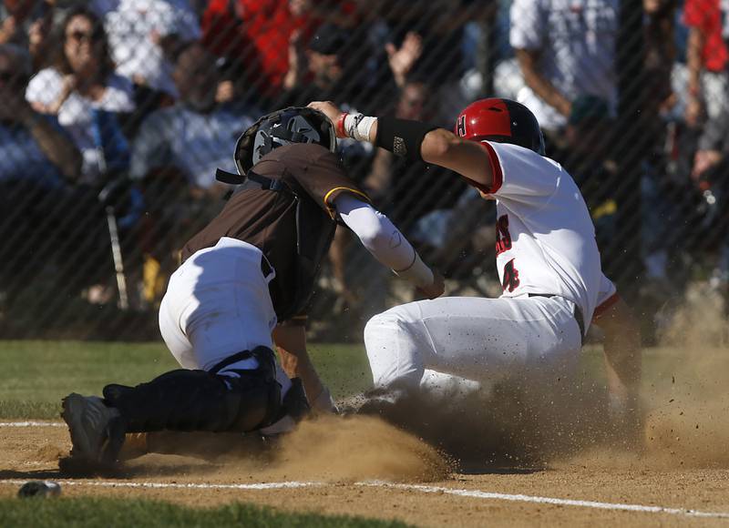 Huntley’s Ryan Quinlan is tagged out by Jacobs's Keegan Connors at home plate during a IHSA Class 4A baseball sectional semi-final baseball game between Jacobs and Huntley at Jacobs High School in Algonquin.
