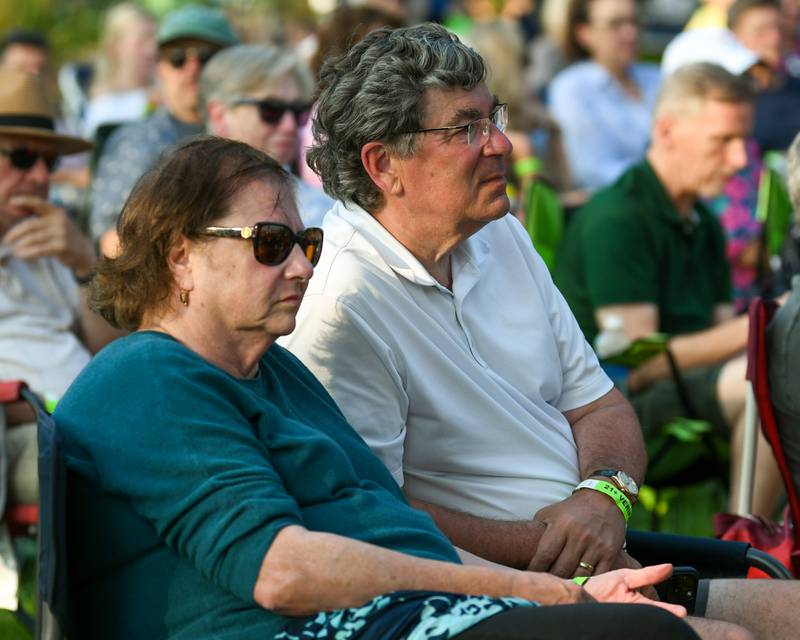 Wheaton Mayor Phil Suess and his wife, Mary Suess, listen to Second Hand News a Chicago-based Fleetwood Mac tribute band on Friday Aug. 2, 2024, before Rocks Off: A Tribute to The Rolling Stones preform at Memorial Park in Wheaton.