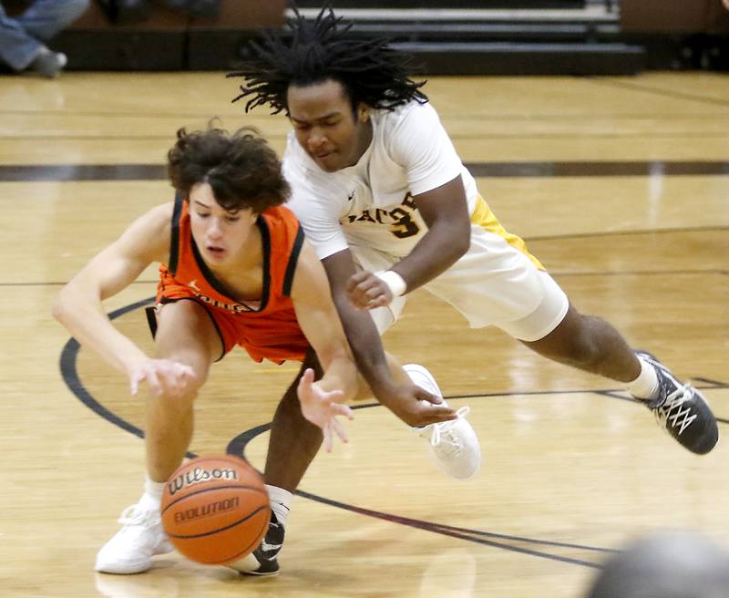 McHenry's Marko Stojich drives after a loose ball in front of Jacobs' Emaan Thomas during a Fox Valley Conference boys basketball game on Wednesday, Nov. 29, 2023, at Jacobs High School in Algonquin.