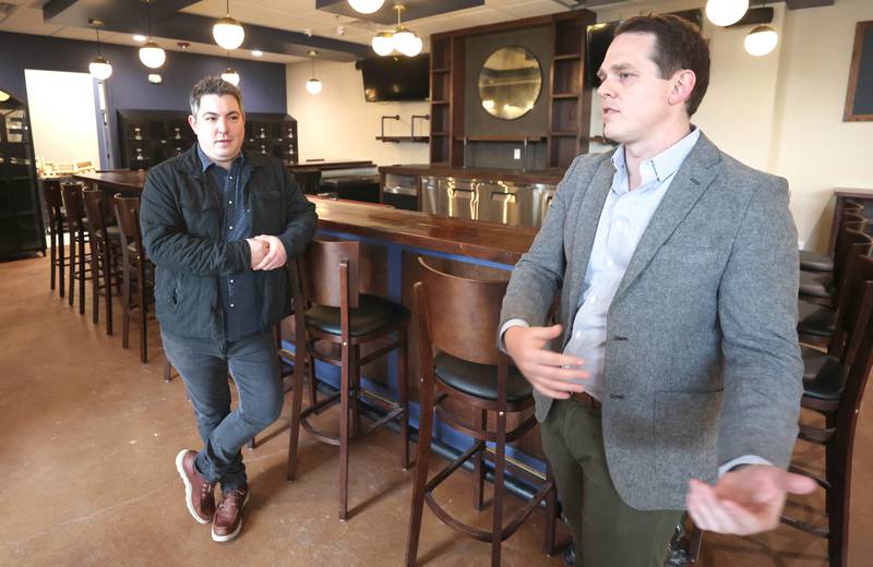 The Grove restaurant and bar owners Jason Engstrom (left) and Sam Patterson talk about their menu Thursday, March 23, 2023, at the new eatery in DeKalb. They plan to open their doors upon completion within the next few weeks.