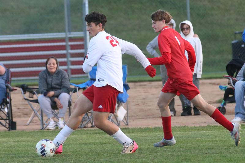 Streator's Keegan Gassman kicks the ball up the field away from L-P's Zac Pescetto during the Class 2A Regional semifinal game on Monday, Oct. 20, 2025 at Ottawa High School.