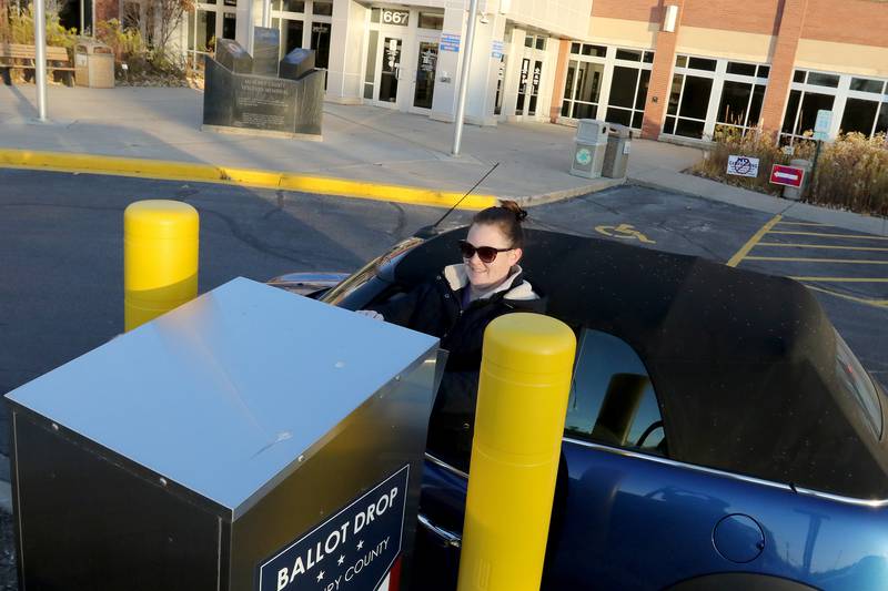 Amy Blank of Island Lake uses the McHenry County Ballot Drop box outside of the McHenry County Administrative Building on Tuesday, Nov. 3, 2020 in Woodstock.