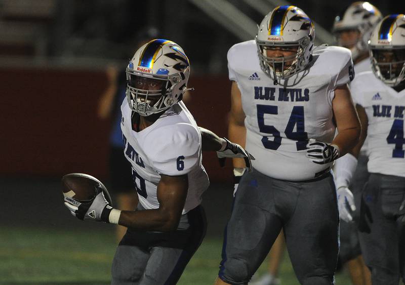 Warren's Maurice Edwards celebrates his first quarter touchdown against Barrington in the varsity football matchup at Barrington High School on Friday.