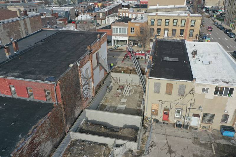 Crews prepare to pour the foundation of a new building at 205-207 W. Main St on Friday, Dec. 8, 2023 downtown Ottawa. The city had to close off Main Street in order to complete the pour.