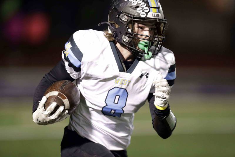 Maine West’s Szymon Grum (8) hustles back a kick return Friday October 28, 2022 in St. Charles.