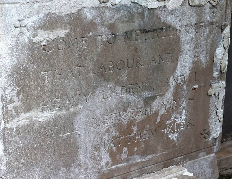 A Bible verse from the Book of Matthew is inscribed near the front door of the long-vacant former St. Mary’s Hospital at 145 Fisk Ave. on Wednesday, July 30, 2025, in DeKalb.