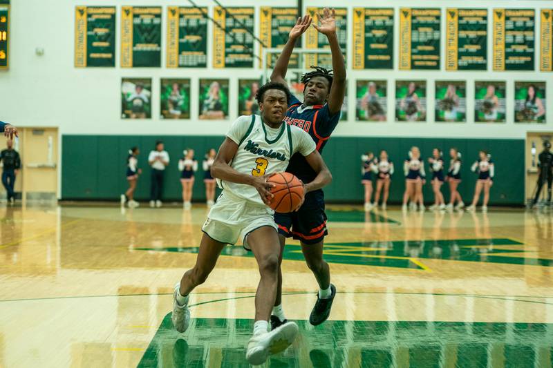 Waubonsie Valley's Tre Blissett (3) drives to the hoop against Oswego’s Jayden Riley (4) during a Waubonsie Valley 4A regional semifinal basketball game at Waubonsie Valley High School in St.Charles on Wednesday, Feb 22, 2023.