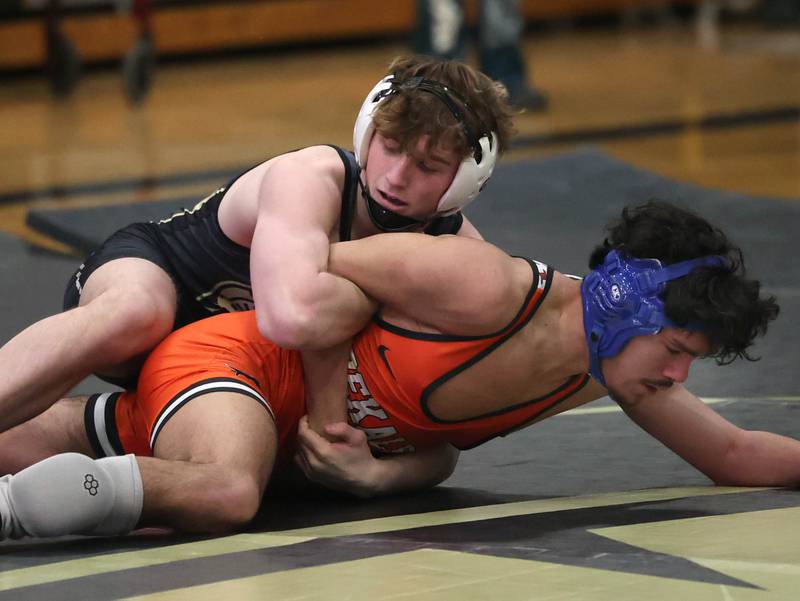 Sycamore’s Jayden Dohogne wrestles DeKalb’s Gabriel Flores at 144 pounds Friday, Jan. 16, 2026, at Sycamore High School.
