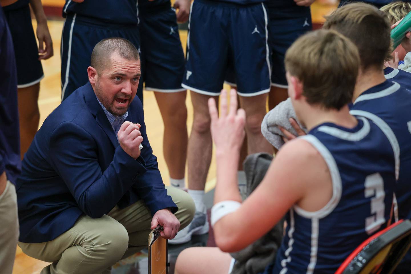 Coach Jeremy Hahn of Fieldcrest talks to players during time out on Saturday, December 14, 2024 at Hall High School in Spring Valley.