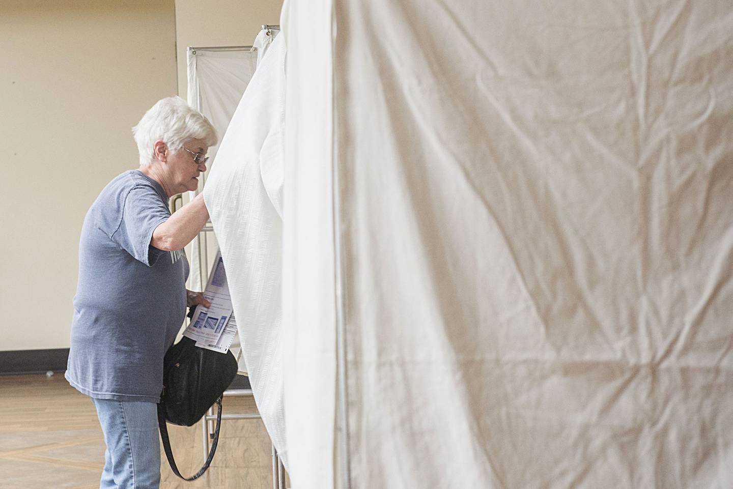 Lona Berkeley of Dixon enters the voting booth at the Holloway Center to cast her ballot Tuesday, June 28, 2022 for the state primary.