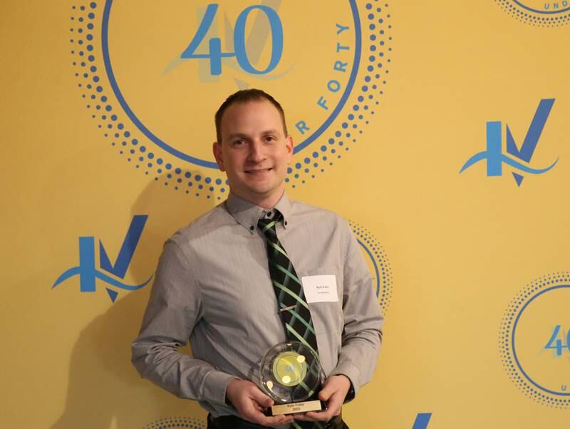 Kyle Foley poses for a photo with his award during the 40 Under Forty awards banquet on Thursday, March 21, 2024 at Westclox in Peru.