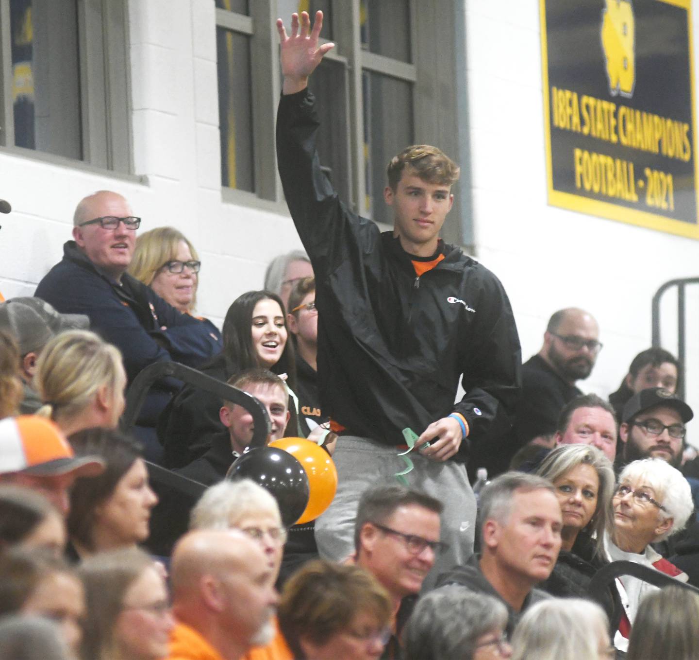 Trey Selman of Milledgeville raises his hand as he stands in the Milledgeville crowd after his raffle ticket was pulled as the winner in the 50/50 raffle held at Polo High School Oct. 13 during the volleyball match with the Marcos. Proceeds from the raffle, bake, sale and silent action will benefit two Milledgeville teens who were critically injured during an auto accident on Sunday, Oct. 9. The split for the 50/50 raffle was $610 and Salman, a graduate of Mllledgeville High School, donated his share back to the teenagers and their families.