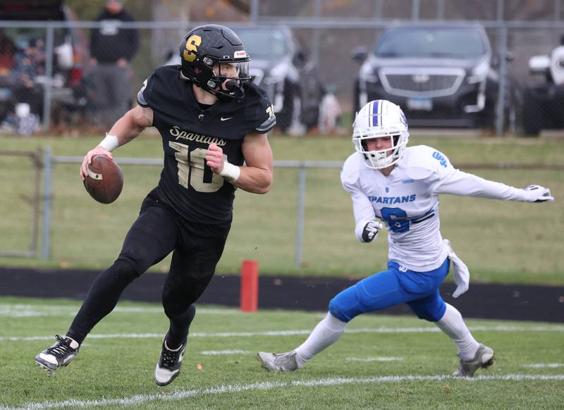 Sycamore's Burke Gautcher rolls away from St. Francis' Jeremy Cox Saturday, Nov. 16, 2024, during their Class 5A quarterfinal game at Sycamore High School.