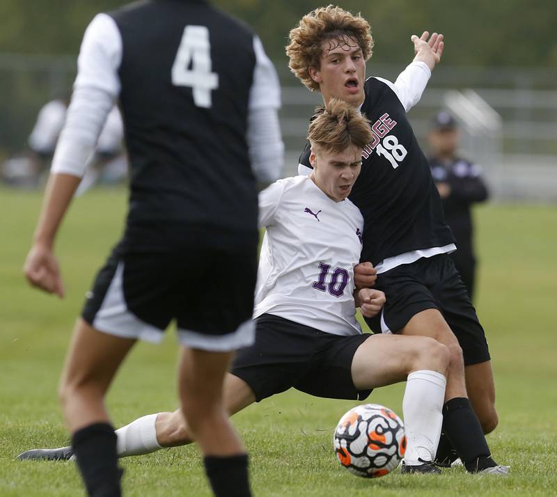 Hampshire's Isaac Ludwig knocks Prairie Ridge's Henry Knoll of the ball during a Fox Valley Conference soccer match Tuesday, Sept. 19, 2023, at Prairie Ridge High School in Crystal Lake.