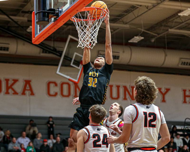Joliet West's Ethan Hillsman (32) attempts a put back dunk during their basketball game between Joliet West at Minooka. Jan 17, 2025 in Minooka.