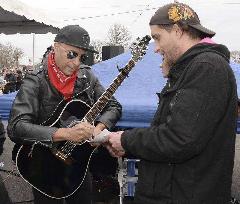 Rage Against the Machine’s Tom Morello, who performed Thursday, April 28, 2022, as The Nightwatchman, signs autographs for fans before hitting the stage for a performance honoring Steve Sutton who was shot and killed during a 1932 labor riot in Marseilles.