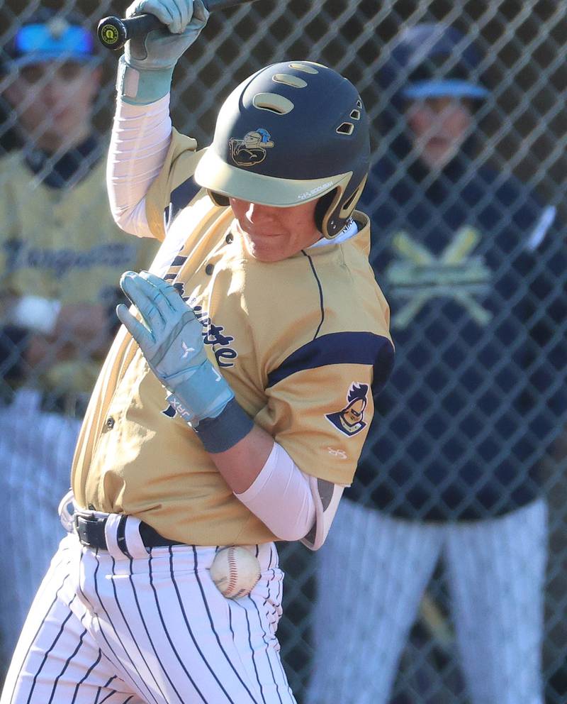 Marquette's Grady Dose gets hit in the hip by a ball at the plate against Newark on Monday, March 23, 2026 at Newark High School.