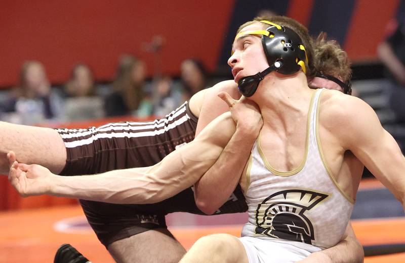 Sycamore’s Gus Cambier (front) wrestles Joliet Catholic’s Connor Cumbee Saturday, Feb. 18, 2023, in the Class 2A 152 pound 3rd place match in the IHSA individual state wrestling finals in the State Farm Center at the University of Illinois in Champaign.