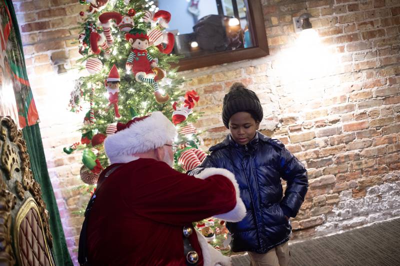 Terris McCrary, 9, of Kankakee, talks with Santa Claus at the Kankakee Train Depot on Thursday, December 4, 2025.