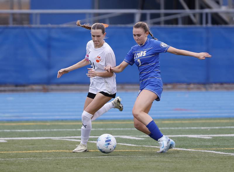 Wheaton Warrenville South's Ashlyn Adams (21) goes for the ball against against Lyons Township's Audrey McCarty (2) during the girl's varsity soccer match between Lyons Township and Wheaton Warrenville South high schools on Thursday, March 27, 2025 in Western Springs.