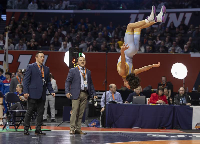 Marquette’s Wesley Janick does a flip after winning the 1A 120 pound state title Saturday, Feb. 21, 2026, at the IHSA wrestling finals in Champaign.