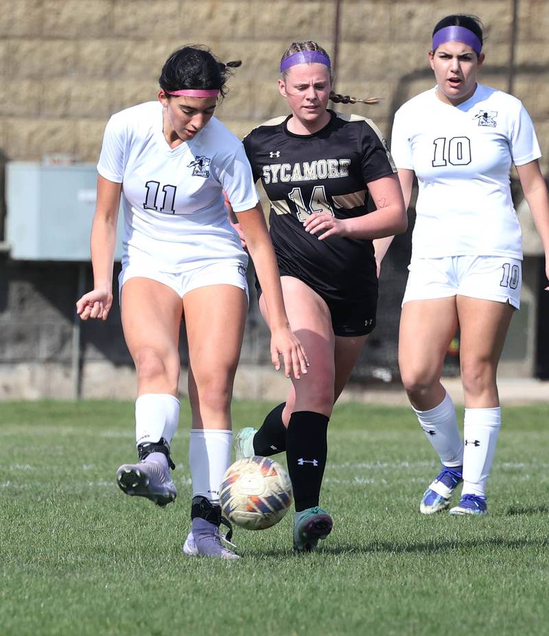Kaneland's Corinne Faivre kicks the ball away from Sycamore's Peyton Wright during their game Monday, April 14, 2025, at Sycamore High School.