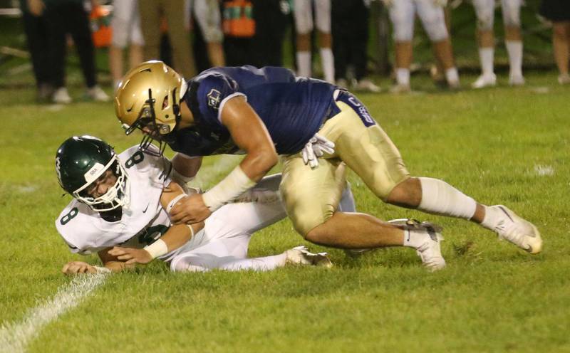 St. Bede quarterback Gino Ferrari fumbles the ball as Marquette's Blayden Cassel gets ready to tackle him on Friday, Sept. 26, 2025 at Gould Stadium in Ottawa.