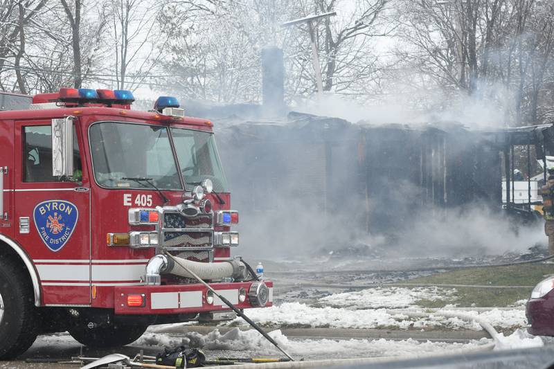 Crews from several area fire departments battled a house fire at 115 W. Third Street in Byron on Saturday morning. One woman was declared dead after being found outside the home after a power line fell on the house causing to become "electrified," a fire official said.