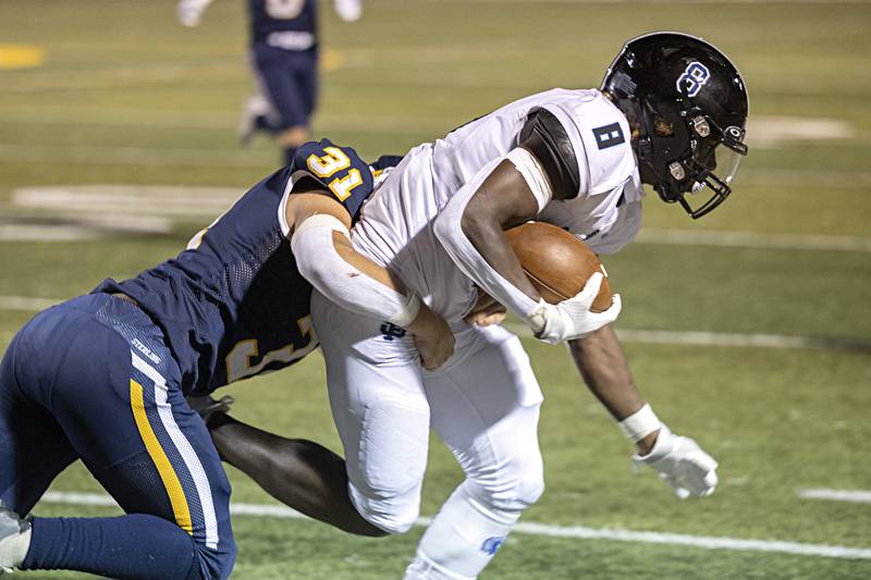 St. Francis’ TyVonn Ransom lis pulled down by Sterling’s Gage Tate Friday, Sept. 1, 2023 at Sterling High School.