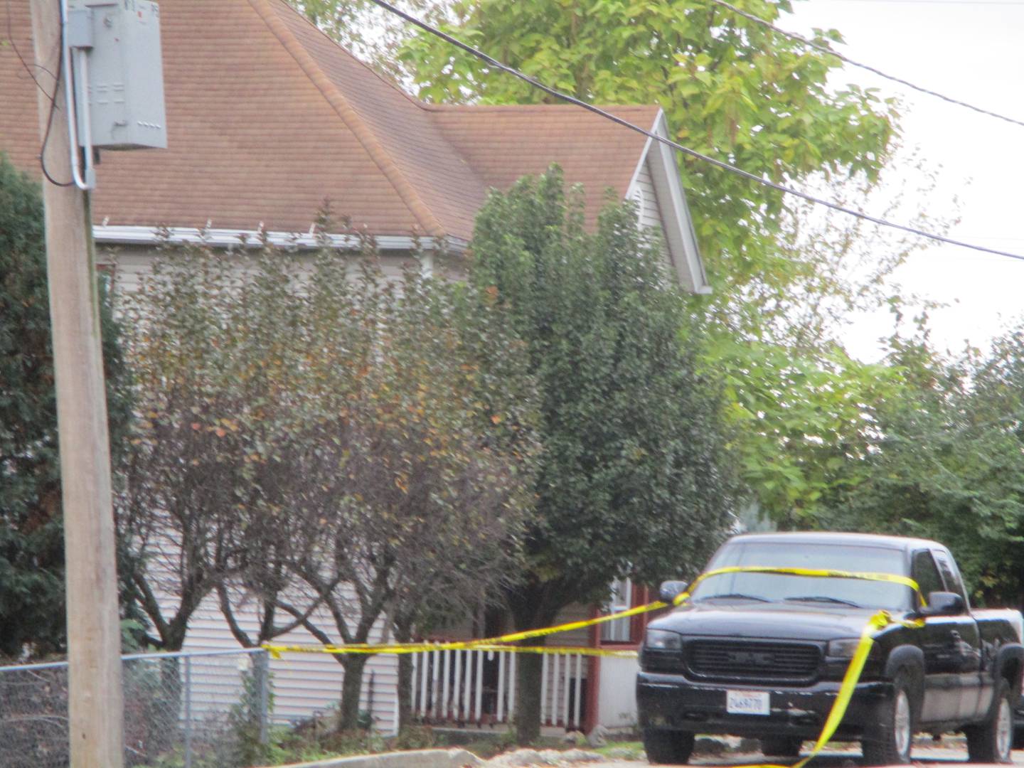 Yellow police tape is tied around a truck outside the house at 1018 E. Jackson St. in  Joliet Township, where two people were killed and 10 injured in a shooting at a Halloween party at 12:39 a.m. on Sunday, Oct. 31, 2021.