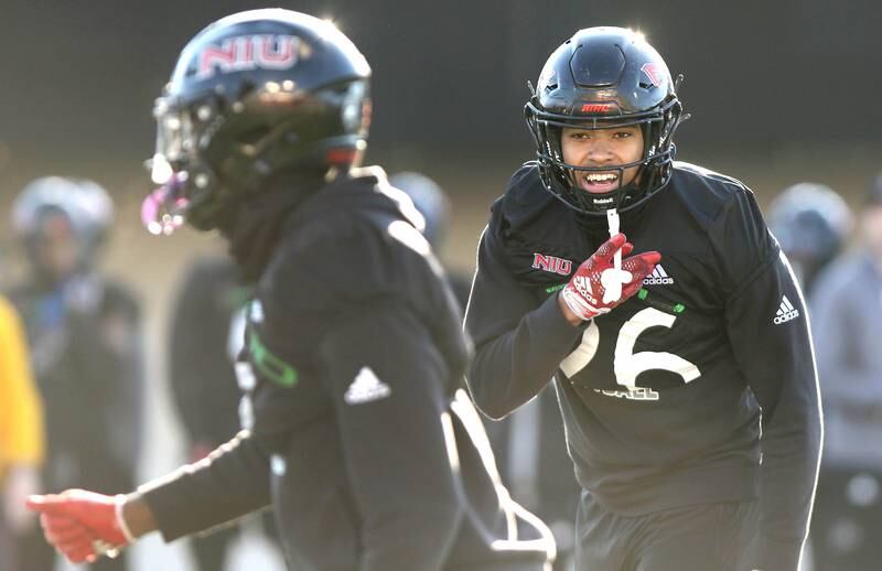 Northern Illinois University junior linebacker Jaden Dolphin (right) calls out instructions to junior linebacker Daveren Rayner during a play at spring practice Friday, April 7, 2023, in Huskie Stadium at NIU in DeKalb.