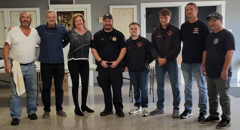Dave and Janet Gonda (second, third from left) of Downer's Grove presented the Naplate First Responders with a check for $7,000 on Tuesday, in gratitude for saving Dave Gonda's life last August.
