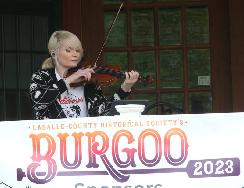 Casey McGrath violinist, plays music on the front porch of the La Salle County Historical Society Canal Market during the 53rd annual Burgoo on Sunday, Oct. 8, 2023 downtown Utica.