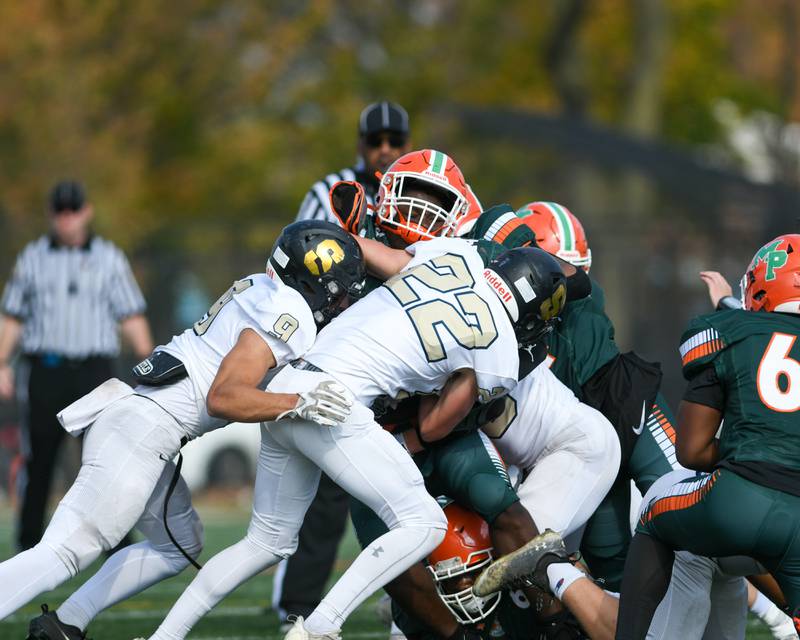 Sycamore's teammates Caden O'donnell (22) and Miles Galindo (9) take down a Morgan Park ball carrier during the second quarter on the game on Saturday Nov. 4, 2023, held at Gately Stadium in Chicago.