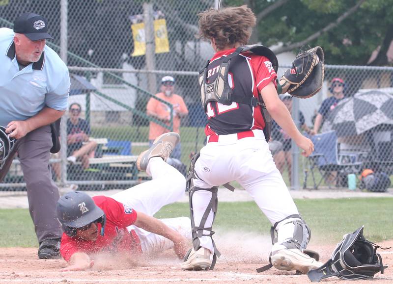 Burbank's Blake Stefanek slides safely across home plate as Spring Valley catcher Carson Riva misses the tag during the Central Regional Senior Baseball Regional tournament at J.A. Happ Field in Washington Park in Peru.