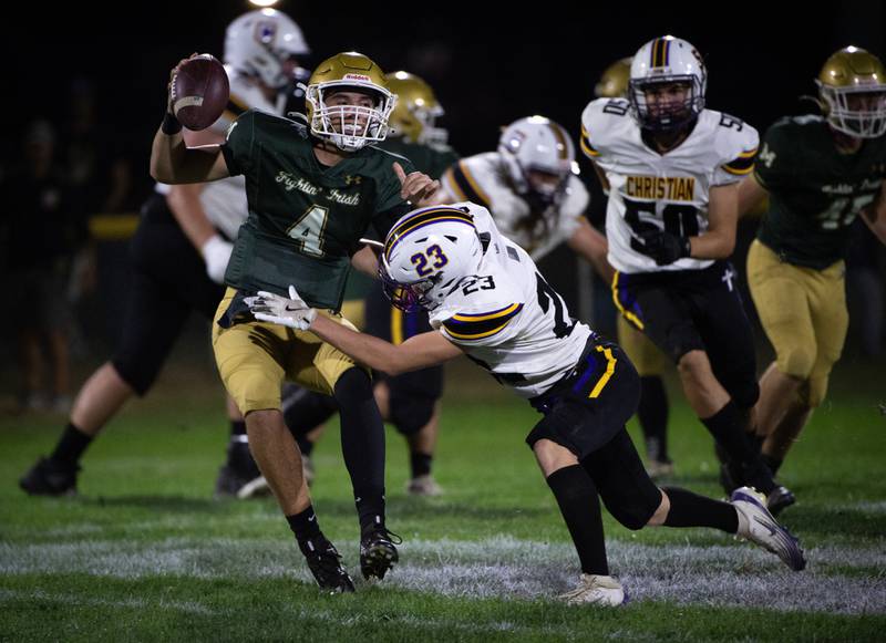 Bishop McNamara's Karter Krutsinger, left, evades a tackle attempt by Chicago Christian's Isaac Workman in a game on Friday, September 19, 2025.