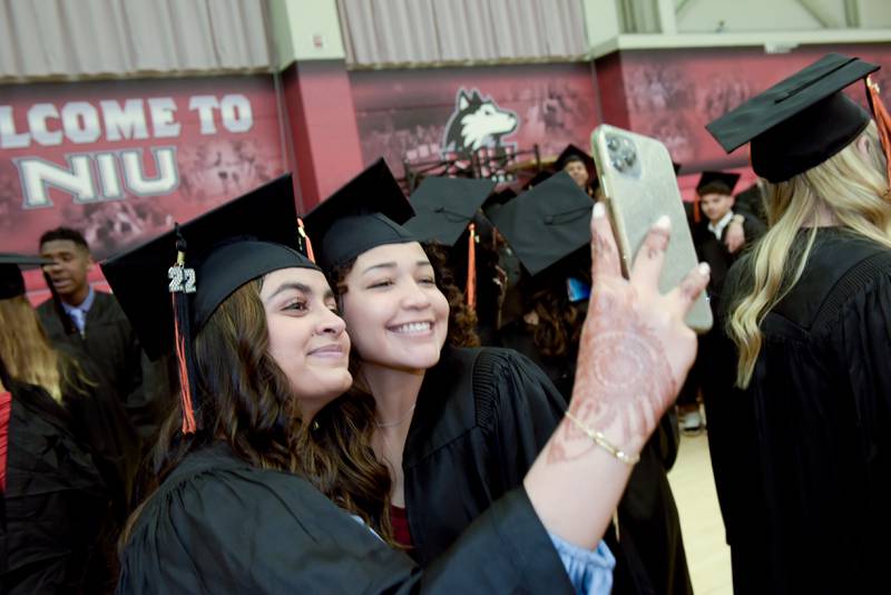 Ifra Faisal and Aria Foster take a selfie before the DeKalb High School graduation ceremony at the Convocation Center in DeKalb on Saturday, May 28, 2022.