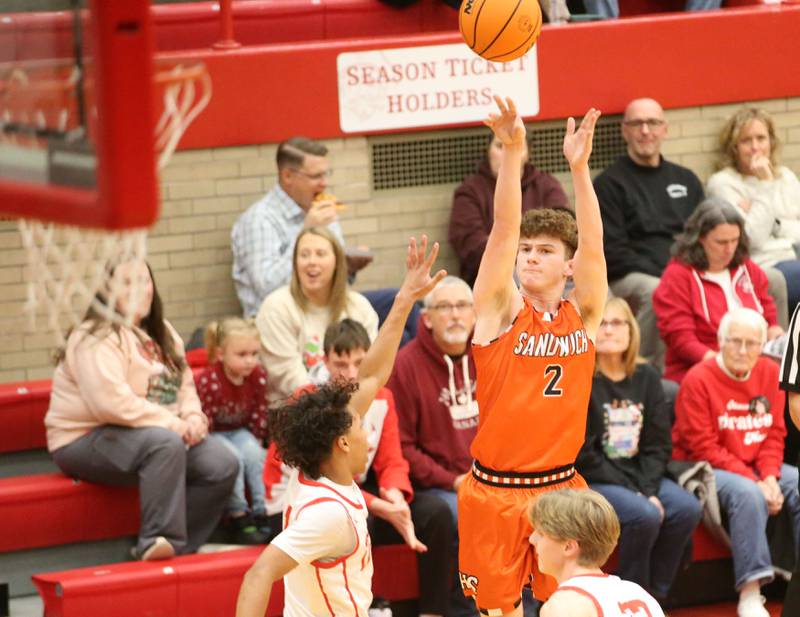 Sandwich's Griffin Somlock shoots a jump shot over Ottawa's Hezekiah Joachim on Wednesday, Dec. 4, 2024 in Kingman Gym at Ottawa High School.