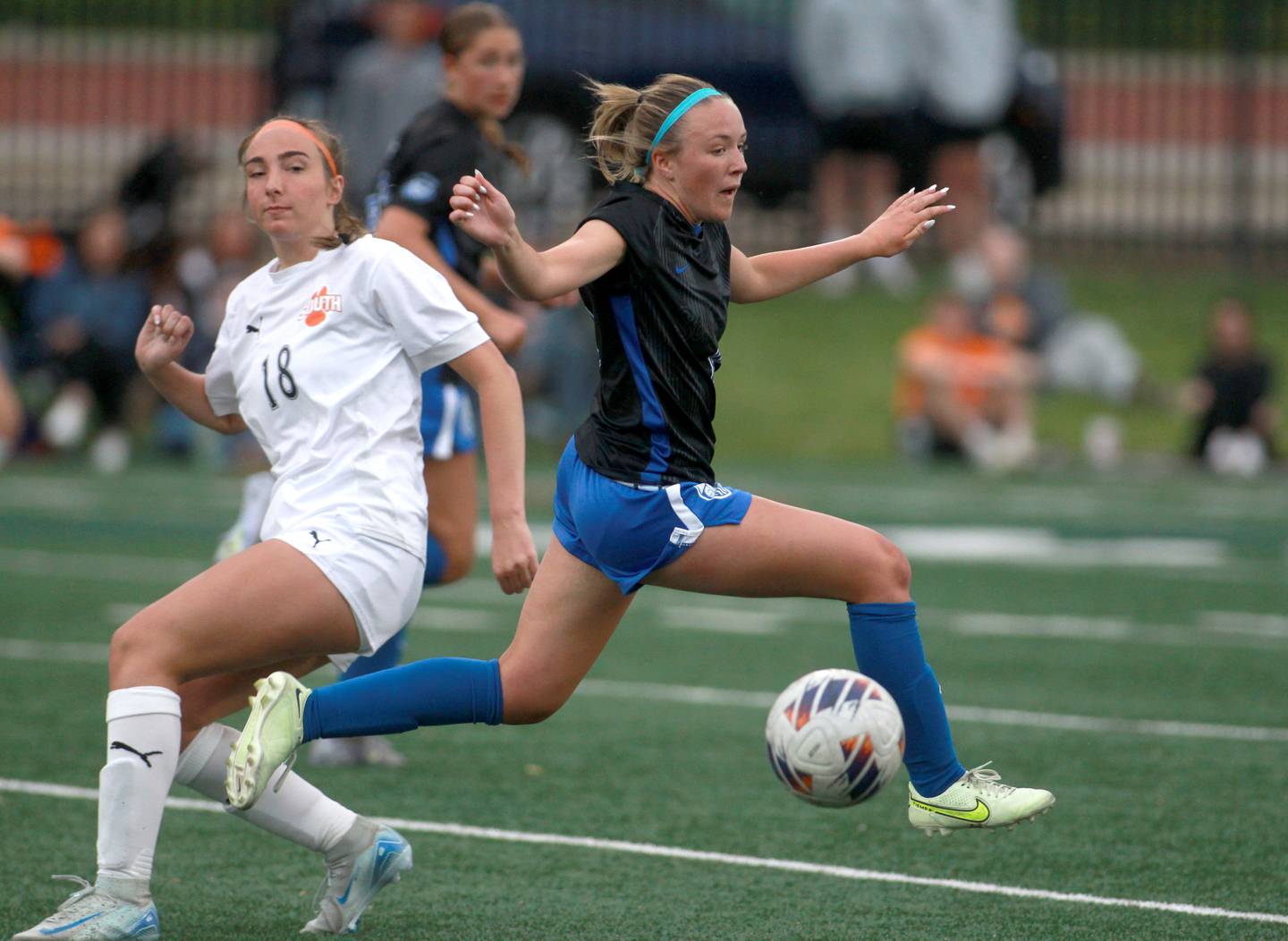 St. Charles North's Keira Kelly chases the ball ahead of Wheaton Warrenville South's Kayla Waterman during the Class 3A Glenbard West Sectional final on Friday, May 30, 2025 in Glen Ellyn.