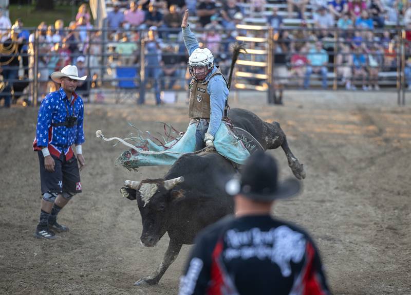 Hunter Ball hangs on Tuesday, August 15, 2023 in the Next Level Pro Bull Riding event at the Whiteside County Fair.