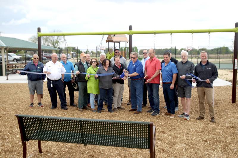 Elburn Village President Jeff Walter (center) is joined by village and Shodeen Homes officials to cut the ribbon for the first phase of the Elburn Station Community Park. The park was partially funded with a grant from the Illinois Department of Natural Resources. The Village of Elburn, Blackberry Township and Shodeen Construction, LLC funded the remainder of the project.