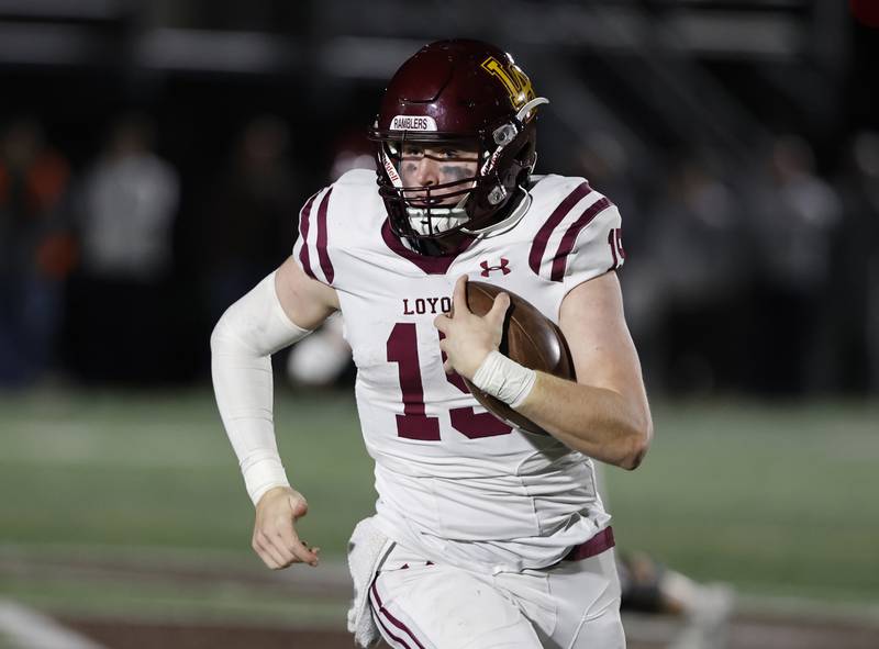 Loyola's Ryan Fitzgerald (15) runs a keeper during the varsity football game between Loyola Academy and Mt. Carmel high school on Friday, Oct. 25, 2024 in Chicago.