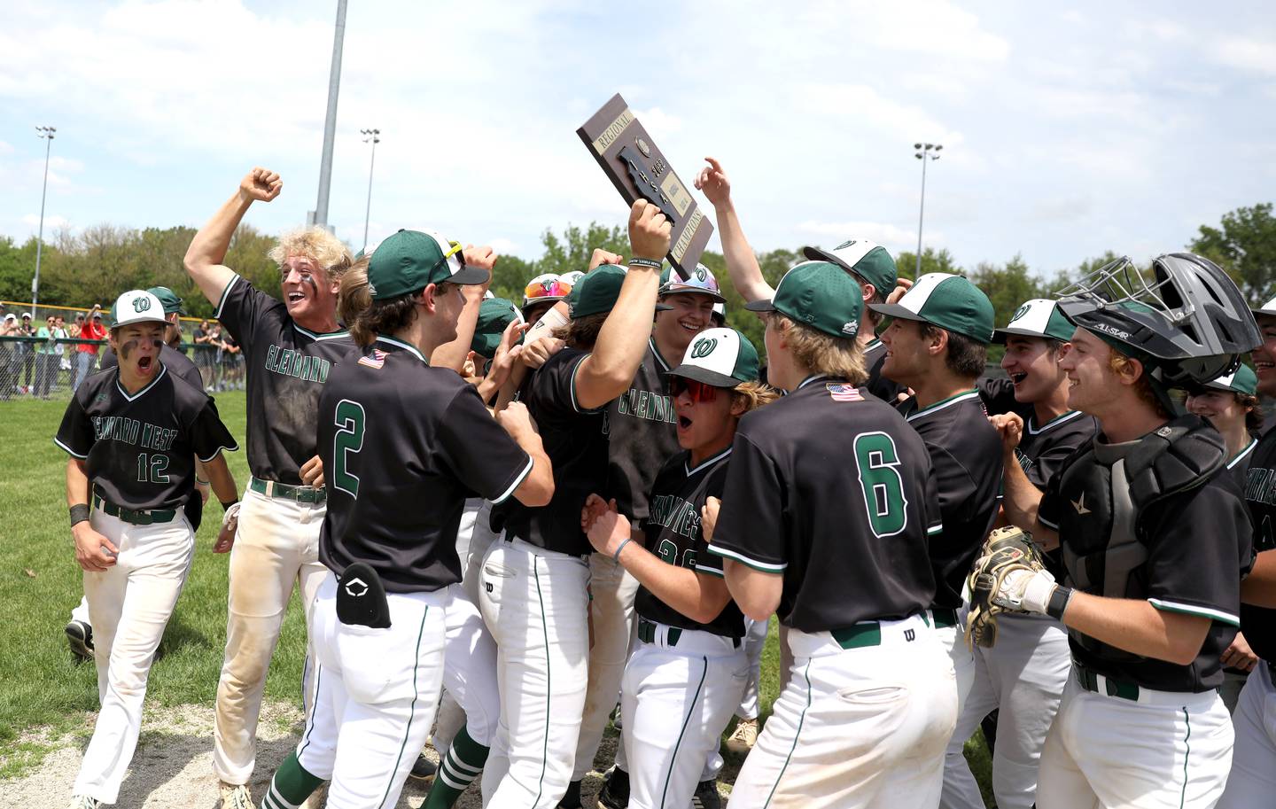 Glenbard West players celebrate their Class 4A Glenbard West Regional final win over St. Charlse East in Glen Ellyn on Saturday, May 28, 2022.