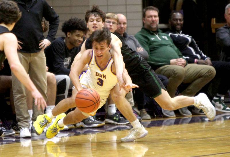 Glenbard West’s Jack Oberhofer (right) turns toward the basket during a game at Downers Grove North on Friday, Jan. 13, 2023.