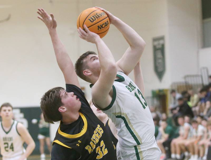 St. Bede's Mason Ross eyes the hoop as Ashton-Franklin Center's Nolan Reuff defends during the Class 1A Regional quarterfinal game on Monday, Feb. 24, 2025 at St. Bede Academy.