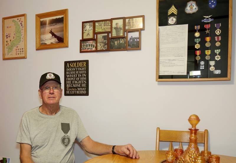 Loren Monsess sits surrounded by medals and other items from his time in Vietnam in Waterman on Saturday, Oct. 28, 2023.