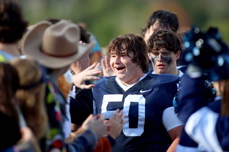 Cary-Grove’s Brady Buhl and the Trojans are greeted by fans after a win over Sycamore in IHSA football Class 5A first-round playoff action at Al Bohrer Field on the campus of Cary-Grove High School in Cary on Saturday, November 1, 2025.