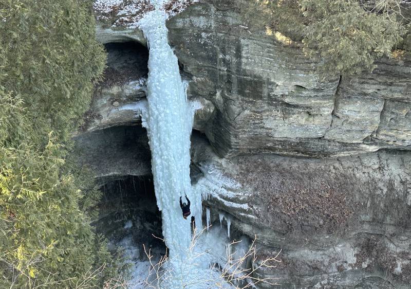 An ice climber scales a 80-foot frozen waterfall inside Wildcat Canyon on Friday, Jan. 24, 2025, at Starved Rock State Park.