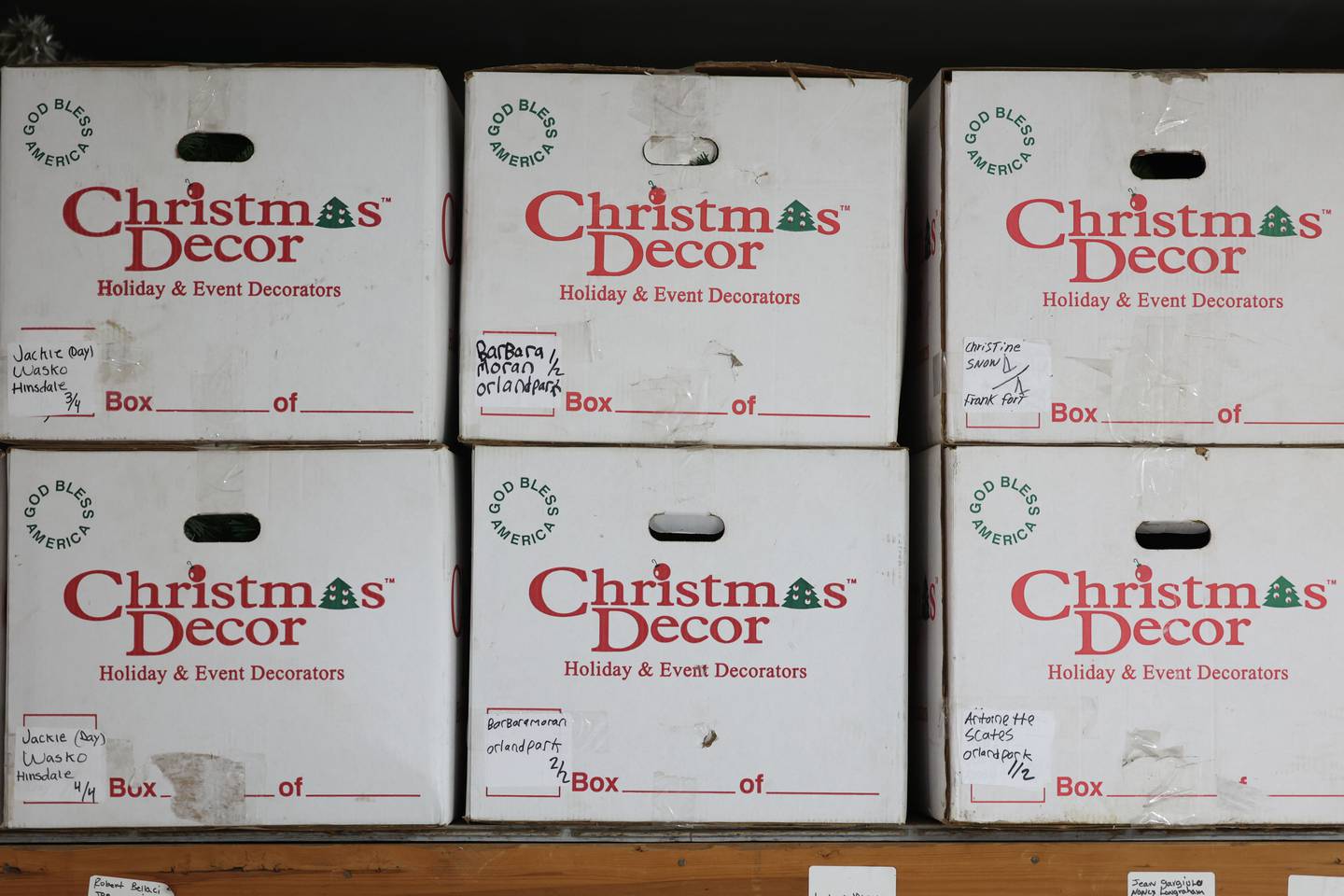 Christmas light boxes line the upper shelves in the warehouse of Gary Fouts’ lighting business in New Lenox on Tuesday, June 20, 2023.