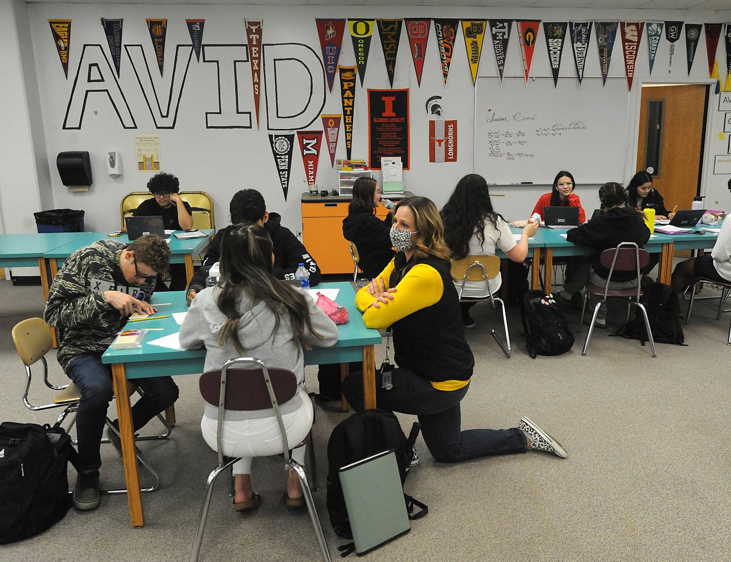 Teacher Kristin Fries talks with student Linda Corral on Tuesday, March 22, 2022, as she teaches the Advancement Via Individual Determination class for seniors at Jacobs High School in Algonquin.